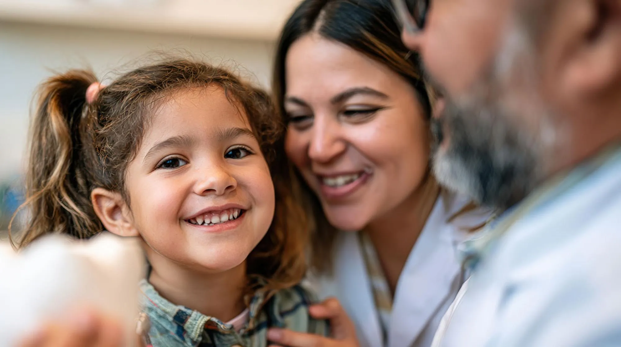Happy family smiling together at a dental appointment, reflecting AltaVia Dental’s welcoming approach to family dentistry.