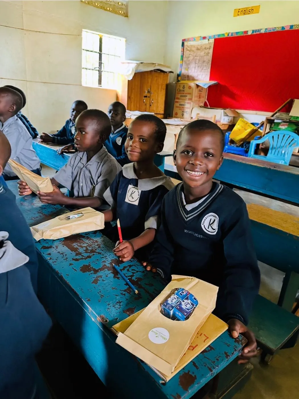 Children in Uganda receiving oral health supplies donated through the Olive Root Foundation
